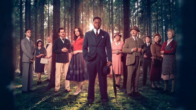 Collection of the cast standing in a forest from Murder is Easy