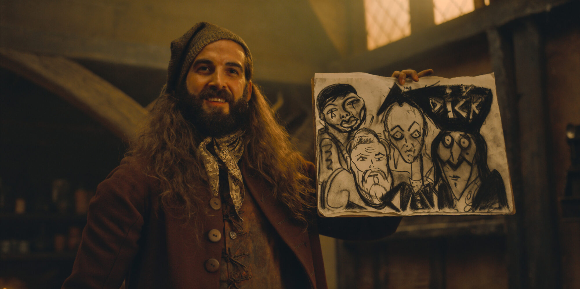 An artist in the tavern holds up is bad drawing of the new Essex Gang from The Completely Made-Up Adventures of Dick Turpin